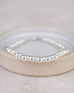 Sterling silver two-bead bracelet by Lucy Kemp Jewellery featuring minimalist jewelry design and smooth bead accents.