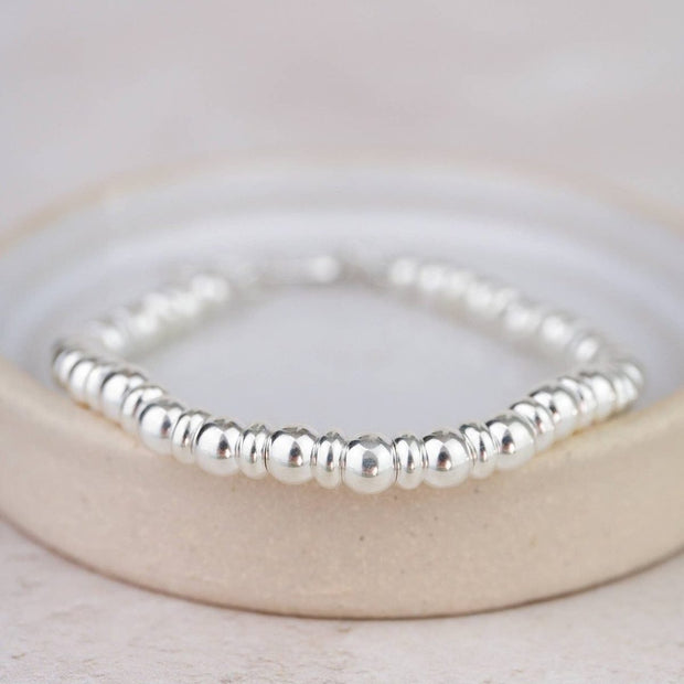 Sterling silver two-bead bracelet by Lucy Kemp Jewellery featuring minimalist jewelry design and smooth bead accents.