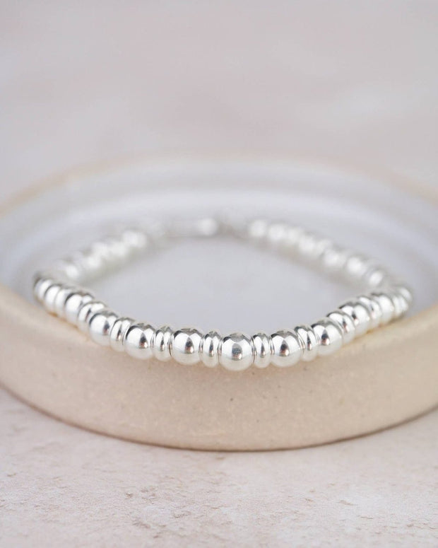 Sterling silver two-bead bracelet by Lucy Kemp Jewellery featuring minimalist jewelry design and smooth bead accents.