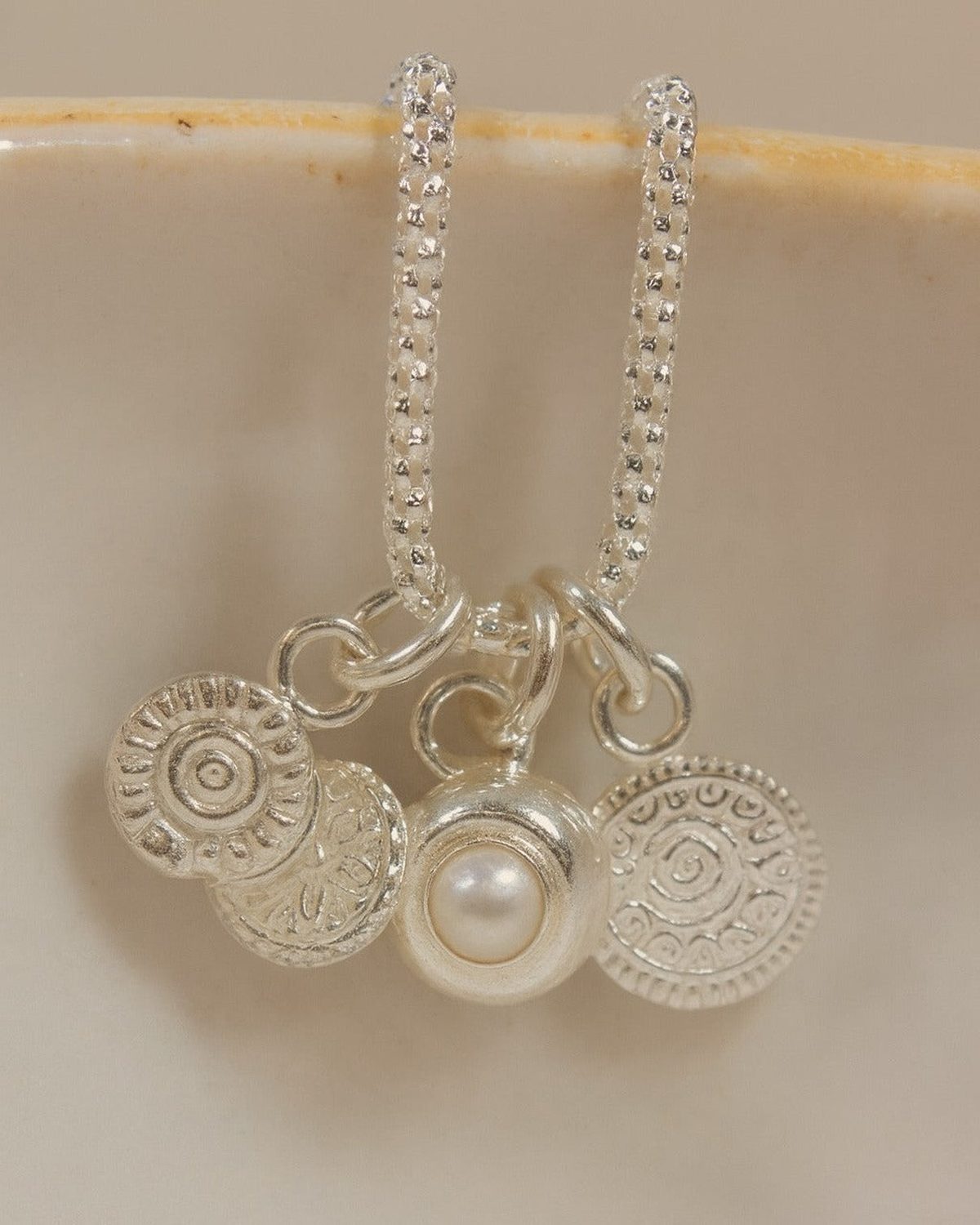 Sterling silver talisman gemstone cluster necklace featuring pearls and colorful gemstones, crafted by Lucy Kemp Jewellery.
