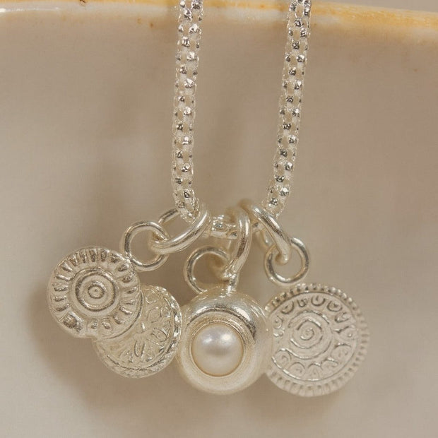Sterling silver talisman gemstone cluster necklace featuring pearls and colorful gemstones, crafted by Lucy Kemp Jewellery.