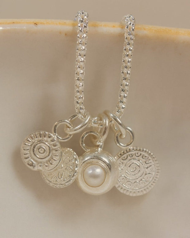 Sterling silver talisman gemstone cluster necklace featuring pearls and colorful gemstones, crafted by Lucy Kemp Jewellery.