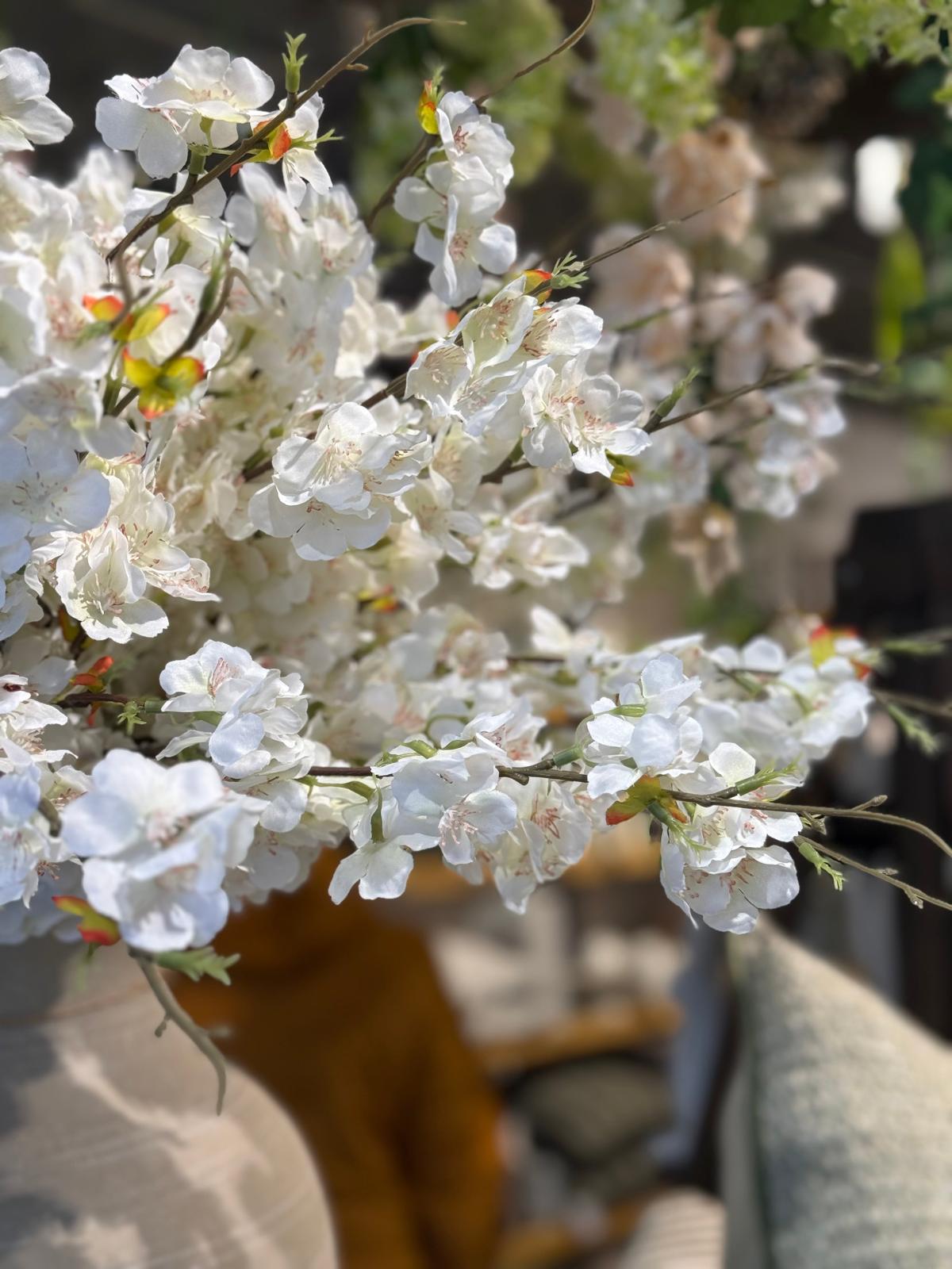 Artificial white blossom stem from Lulu Loves Home, featuring realistic white flowers on a green stem for home décor.