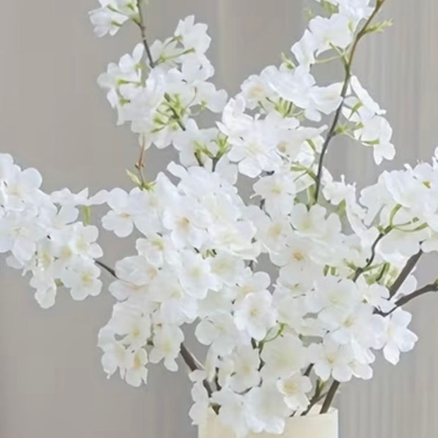 Artificial white blossom stem from Lulu Loves Home, realistic artificial plant with white flowers and green stems.