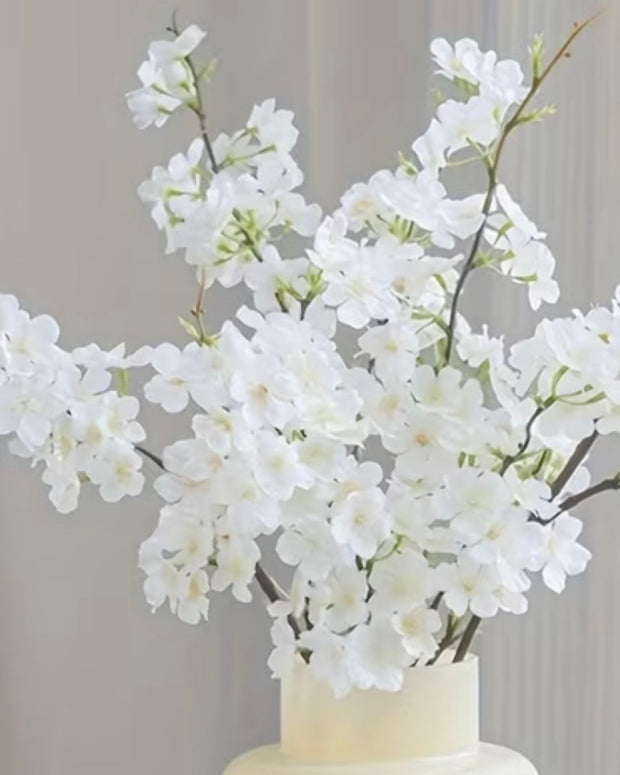 Artificial White Blossom Stem from Lulu Loves Home, detailed faux plant with white blossoms and green stems for decorative use.
