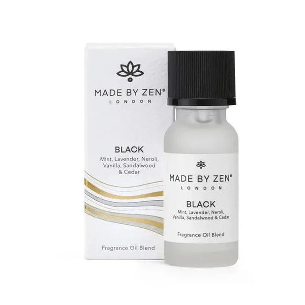 Made By Zen black diffuser and burner with signature scent fragrance oil for home aromatherapy, displayed on a wooden surface.