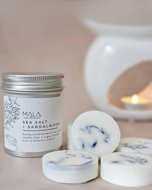 Luxury wax melt tins by MALA Home Fragrance featuring sea salt and sandalwood scent, displayed in elegant tins for home fragrance.