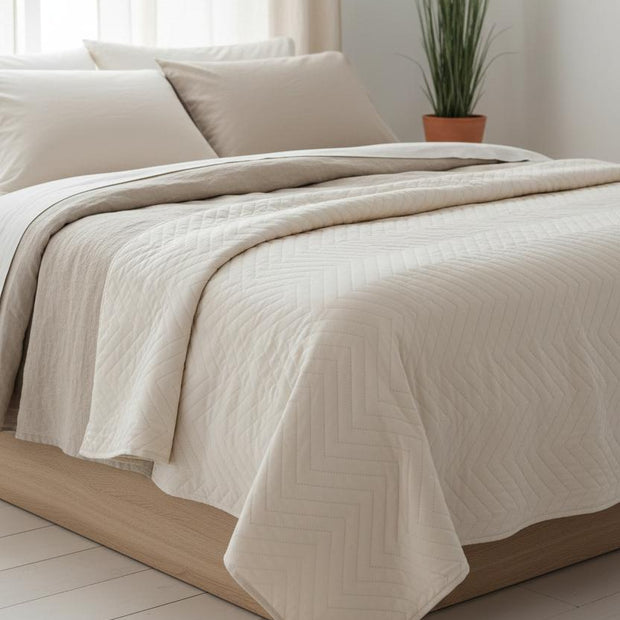 Malini Amelle Ivory Cream queen size quilted bedspread with soft, textured fabric and elegant stitching for a cozy bedroom look.