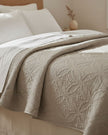 Malini Amity beige king size quilted bedspread with soft, textured fabric for a cozy, elegant bedroom look.