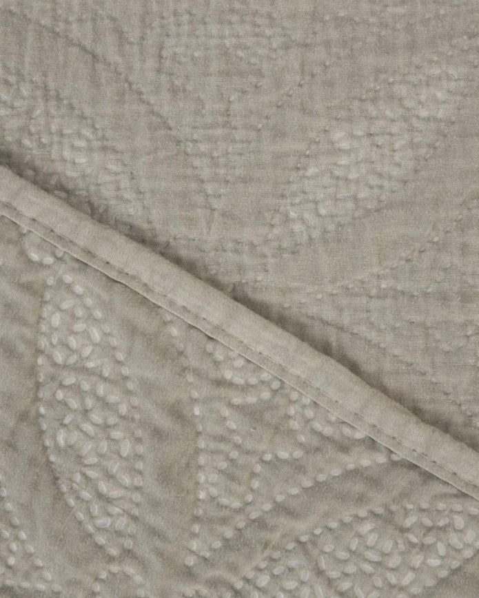 Malini Amity beige king size quilted bedspread with soft, textured fabric and elegant stitching on a neatly made bed.