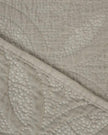 Malini Amity beige king size quilted bedspread with soft, textured fabric and elegant stitching on a neatly made bed.