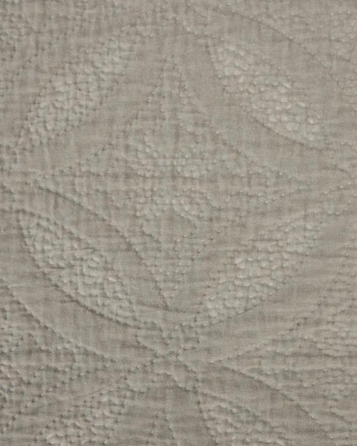 Malini Amity beige king size quilted bedspread with soft, plush fabric and intricate quilting design for a cozy bedroom look.