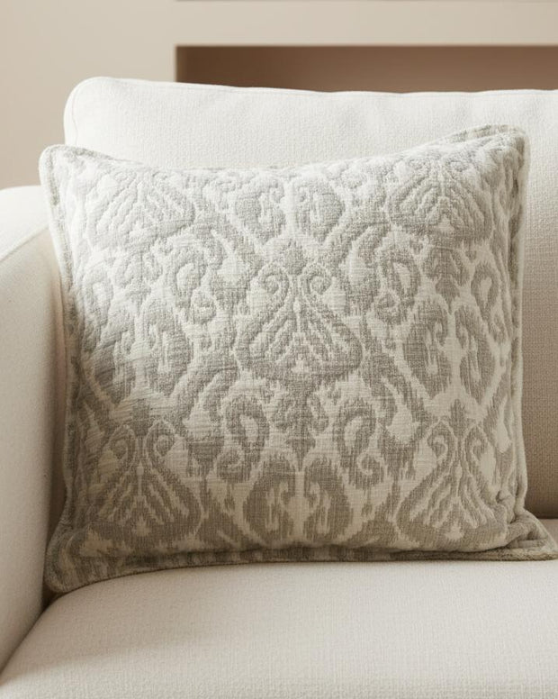 Beige soft jacquard square linen cushion cover by Malini, showcasing intricate woven pattern and smooth fabric texture.