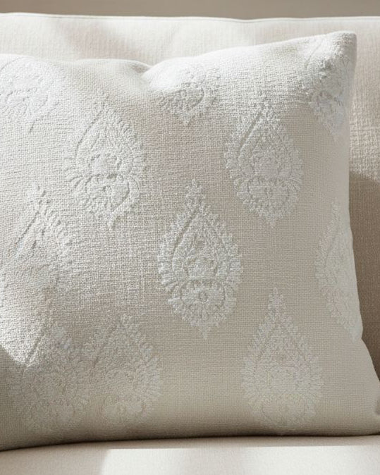 Cream paisley square cushion cover by Malini, soft furnishings with intricate paisley design on fabric.