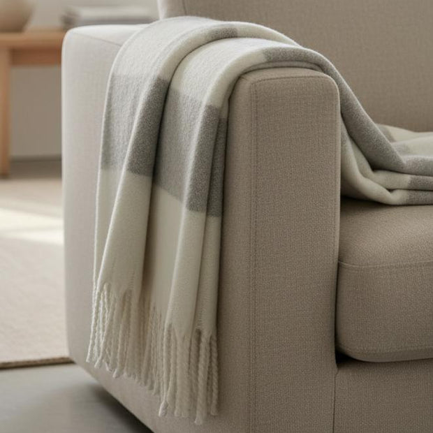 Malini Kalix grey blanket throw made of soft furnishings fabric, displaying a cozy, textured grey throw draped on a sofa.