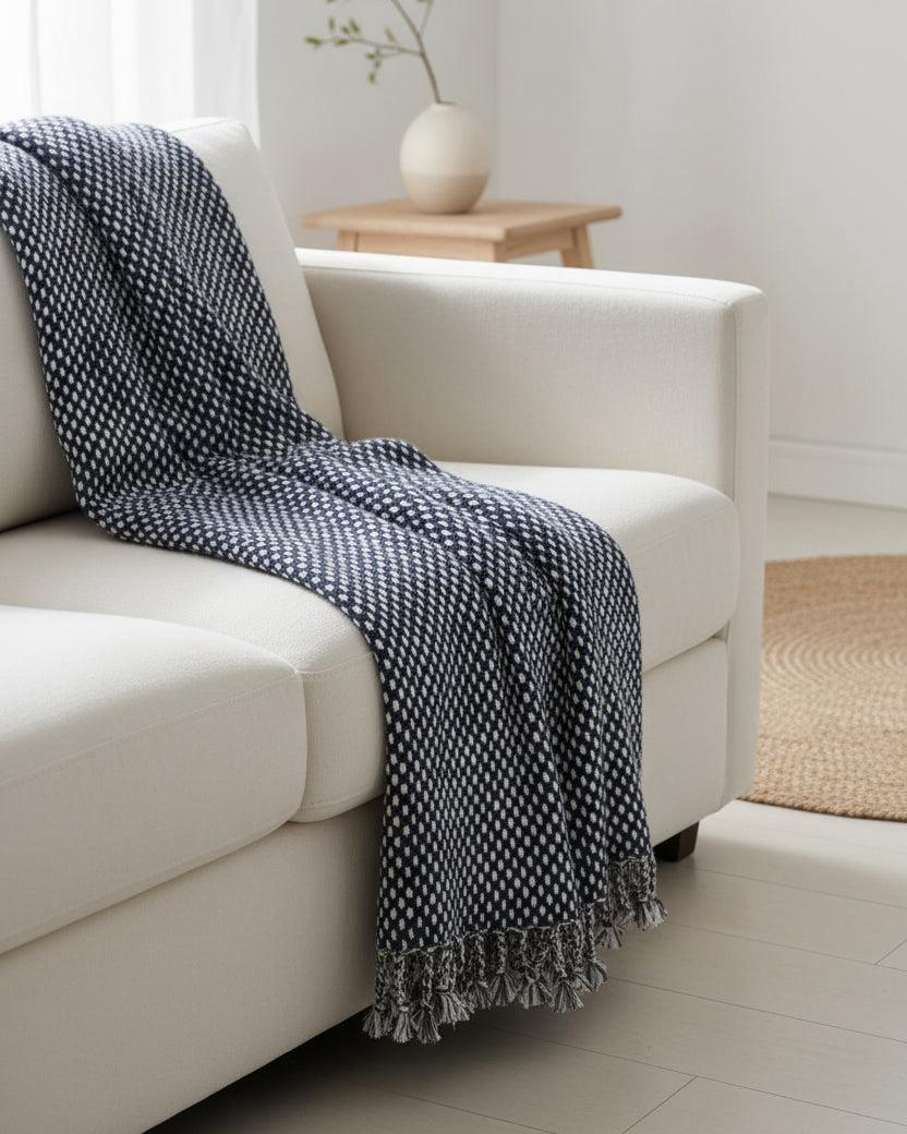 Navy blue Malini rain drop effect blanket throw with soft, textured fabric for cozy home decor.