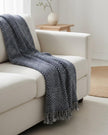 Navy blue Malini rain drop effect blanket throw with soft, textured fabric for cozy home decor.