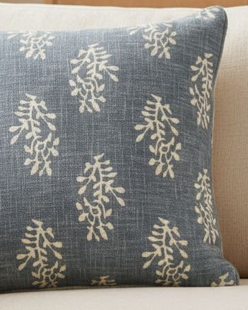 Ocean blue flower cushion cover by Malini featuring a soft block floral pattern on fabric for cozy home decor.