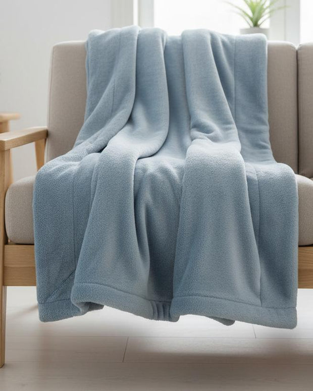 Ocean blue Mia fleece throw blanket by Malini, soft furnishings, cozy and lightweight with plush fleece material and decorative edges.