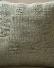 Olive green textured square cushion cover from Malini soft furnishings with a soft, woven fabric and subtle pattern.