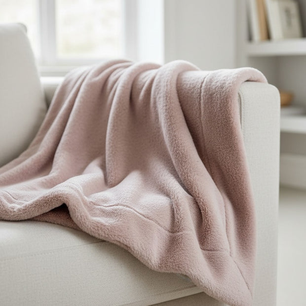 Pale grey floral faux mohair throw blanket from Malini, soft furnishings with a cozy, textured floral pattern.