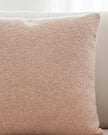 Pink textured cushion cover from Malini soft furnishings, showcasing a soft fabric with intricate surface detailing.