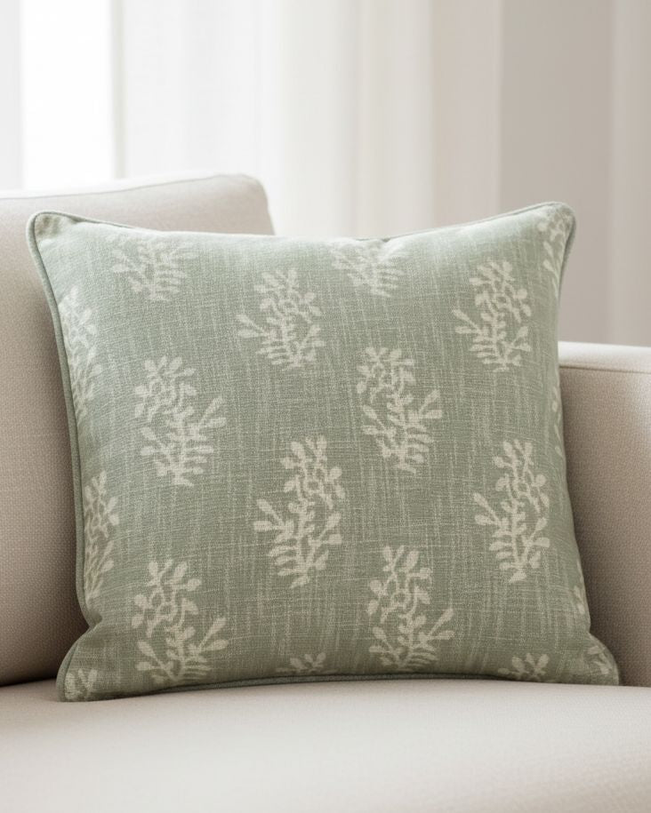 Sage green flower-patterned cushion cover by Malini, soft furnishings with block floral design on fabric.