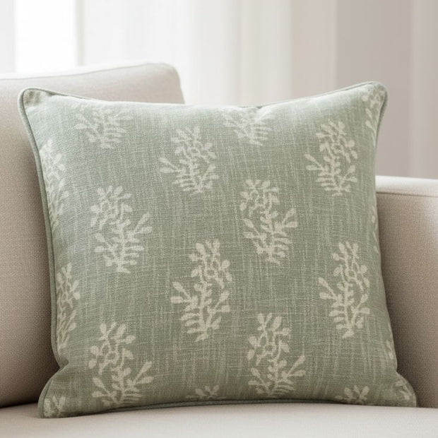 Sage green block flower cushion cover from Malini, soft furnishings with floral pattern and cozy fabric.