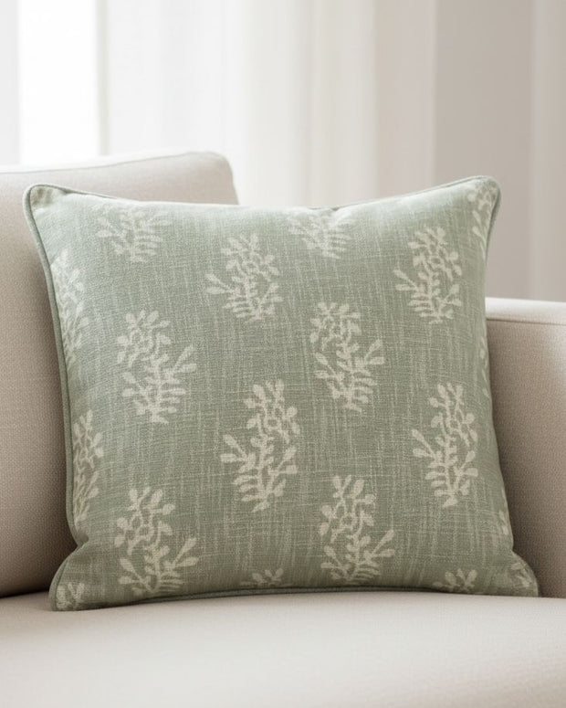 Sage green flower-patterned cushion cover by Malini, soft furnishings with block floral design on fabric.