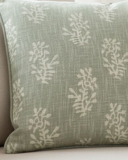 Malini sage green flower cushion cover with a soft block pattern, perfect for adding a cozy touch to living spaces.