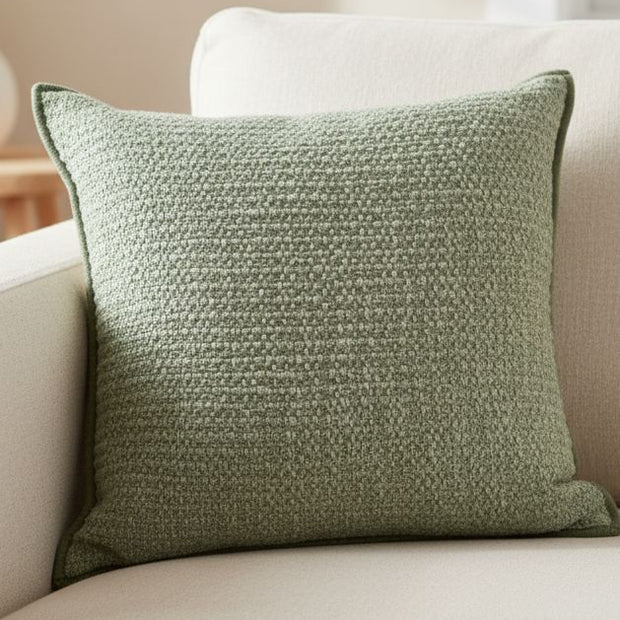Sage green textured cushion cover by Malini, soft furnishings with a woven pattern, perfect for cozy home decor.