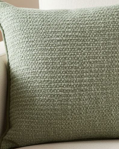 Sage green textured cushion cover from Malini, soft furnishings with a woven pattern and plush fabric for cozy decor.