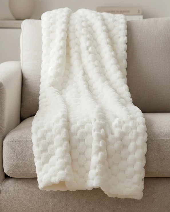 Ivory white Malini Sculpted Faux Bunny Rabbit Throw Blanket made of soft furnishings material, featuring a textured bunny design.