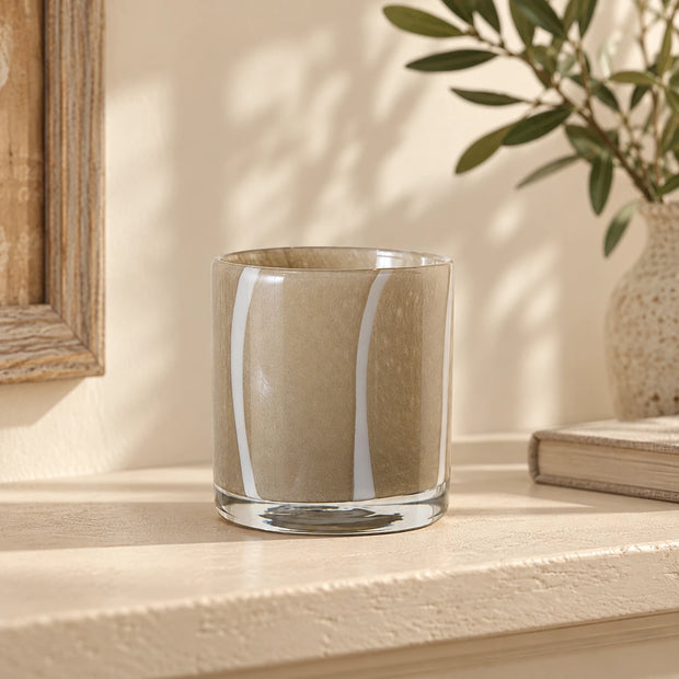 Medium Beige Glass Tealight Holder — vertical white stripe design empty on cream shelf