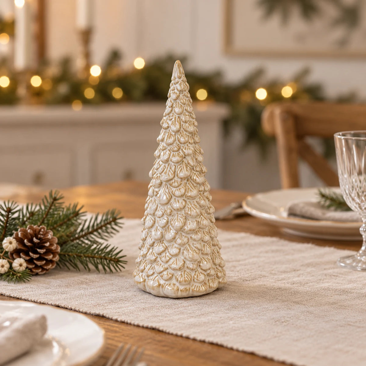 Medium glazed ceramic Christmas tree on an oatmeal linen Christmas table