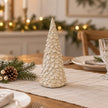 Medium glazed ceramic Christmas tree on an oatmeal linen Christmas table