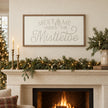 Wood & Metal Sign - White And Gold Meet Me Under The Mistletoe above a cream mantel.