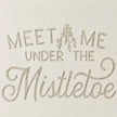 Close-up of original raised script lettering and cream metal surface on Wood & Metal Sign - White And Gold Meet Me Under The Mistletoe.