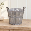 Empty medium Meon planter basket on a pale oak console with its clear liner visible