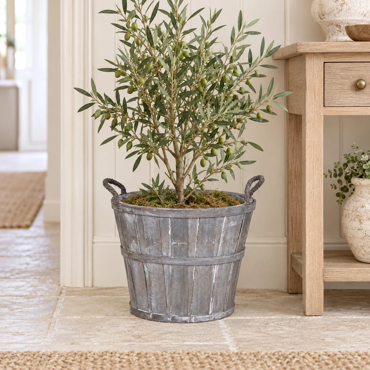 Medium Meon planter basket styled with an olive plant beside an oak hallway console