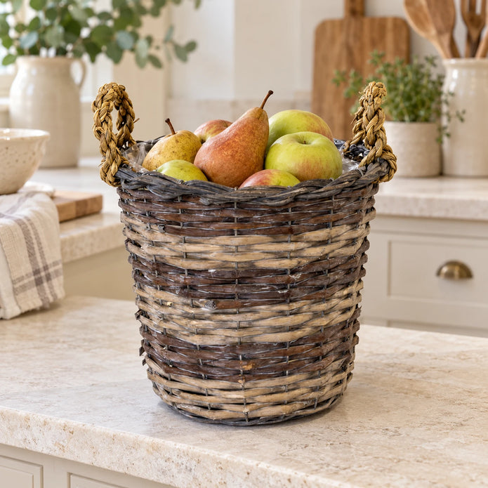 Meon round willow basket styled with pears and apples on a cream kitchen counter