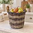 Meon round willow basket styled with pears and apples on a cream kitchen counter