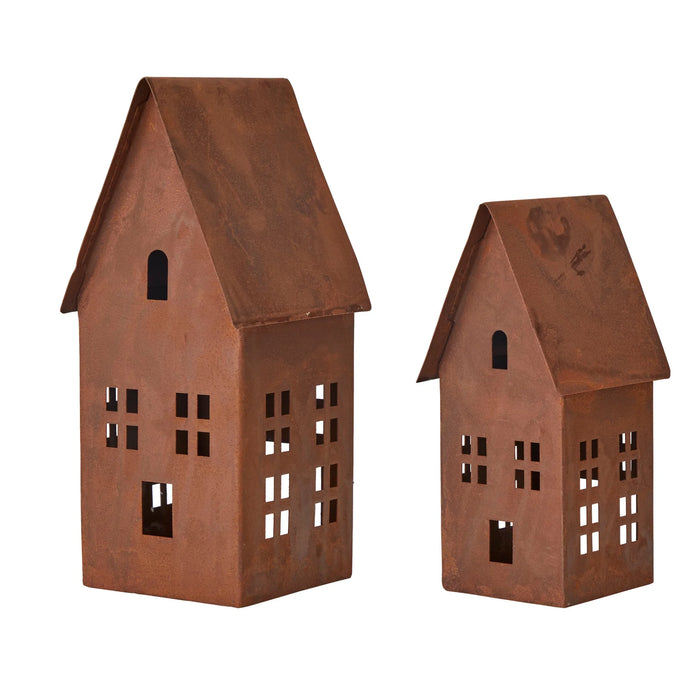 Small and large rust metal house candle holders with steep pitched roofs and window cutouts