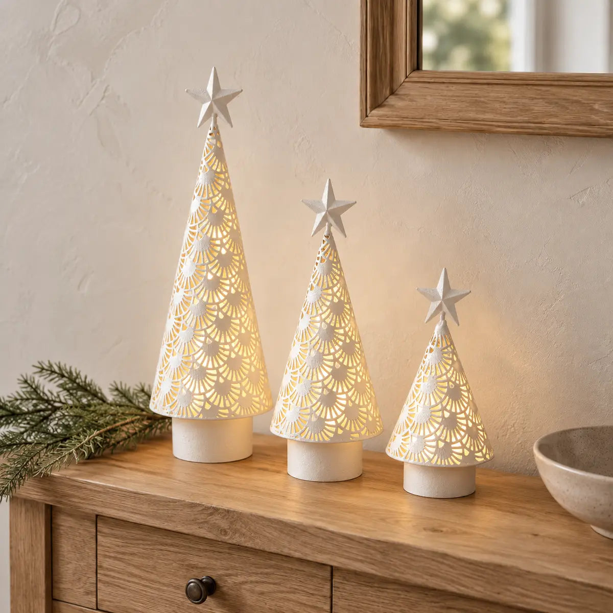 Three sizes of white metal cut-out LED light-up trees styled together