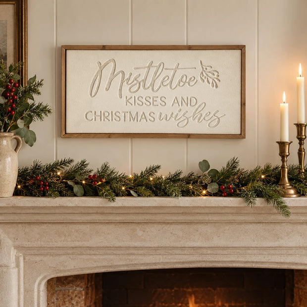 Wood & Metal Sign - White Mistletoe Kisses And Christmas Wishes above a cream mantel.