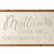Close-up of original raised script lettering and cream metal surface on Wood & Metal Sign - White Mistletoe Kisses And Christmas Wishes.
