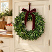Mistletoe Christmas wreath on a cream kitchen cabinet