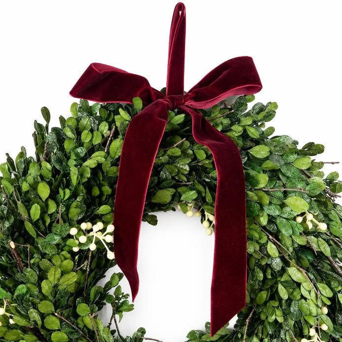 Christmas mistletoe wreath with burgundy bow, decorated with green mistletoe and festive ribbon, perfect for holiday decor.