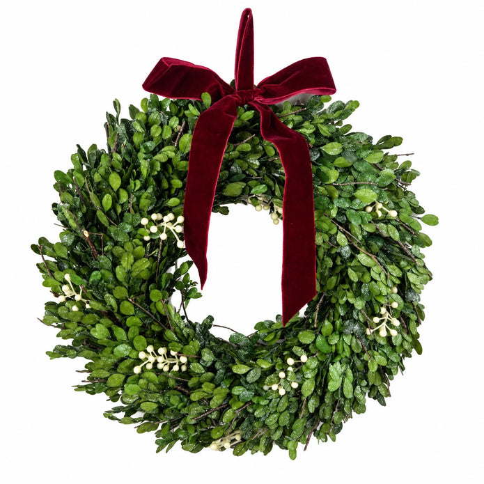 Mistletoe wreath with burgundy bow and ivory berries on white