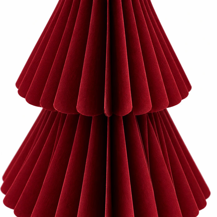 Close-up of burgundy red folded paper and tier edges on a standing Christmas tree.